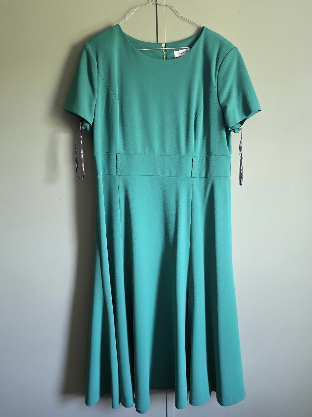 Calvin Klein emerald green fit & flare dress featuring a classic round neckline